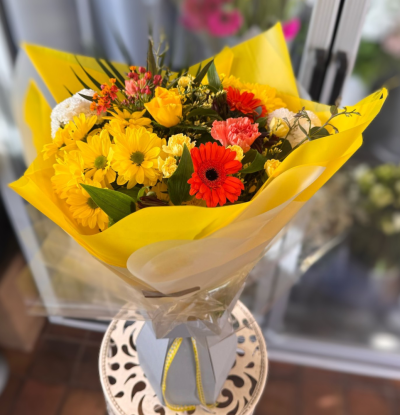Jude - 'Jude' A beautiful selection of seasonal flowers in Orange, Yellows and Whites. Perfect for someone who loves bright colours. Hand-Tied and arranged in water.