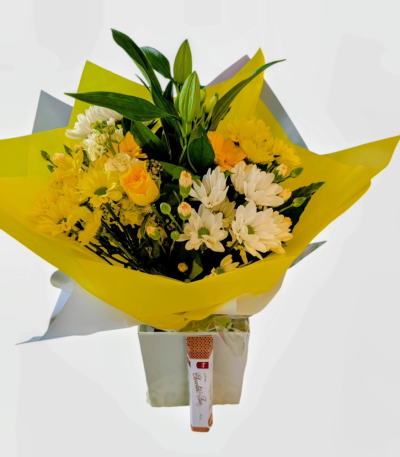 Sunny Days - A Bright & Beautiful selection of seasonal flowers in Yellows, White and Cream, Hand-tied in water. This will definitely brighten up someone's day. Delivered with Hames - Luxury Milk Chocolate Heritage Bar 100g.