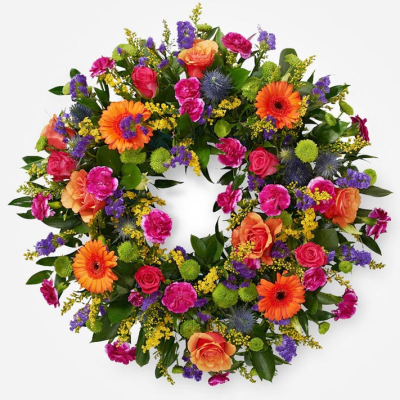 Forever in Bloom Wreath - A vibrant handcrafted wreath of fresh seasonal blooms in bold, cheerful colours, thoughtfully designed to celebrate a life beautifully lived.